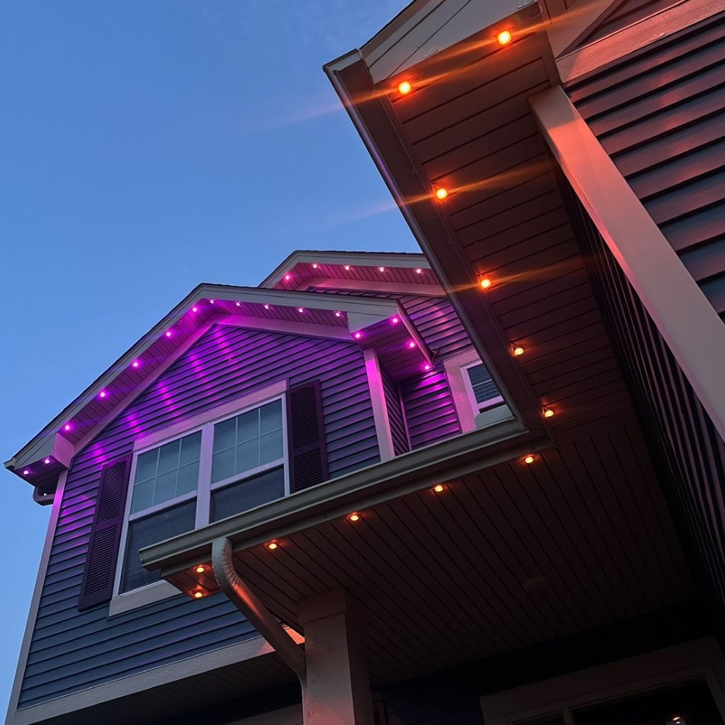 Close-up of orange and purple permanent LEDs beneath roof eaves