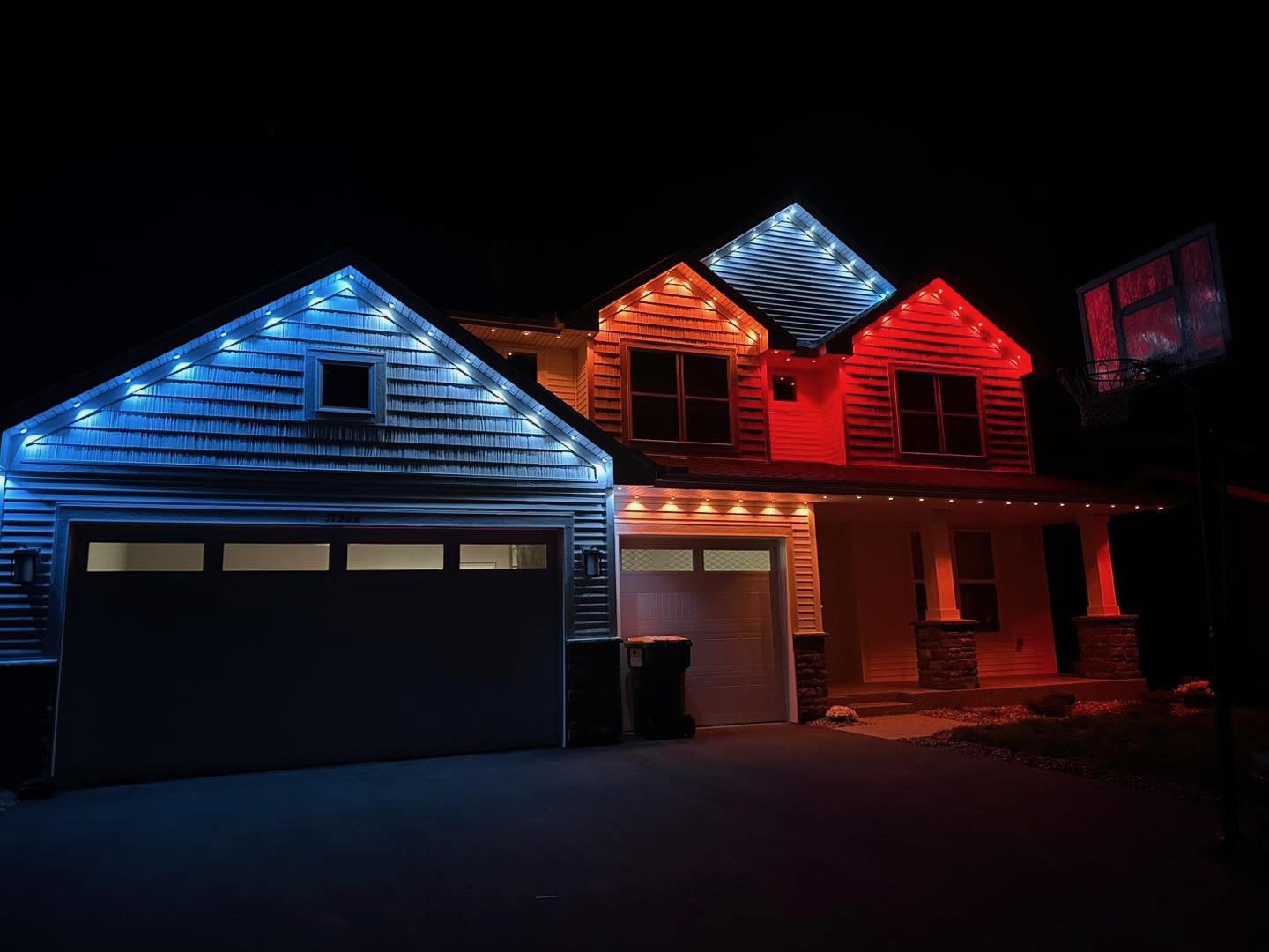 Blue, orange, and red lighting outlining a home and garage